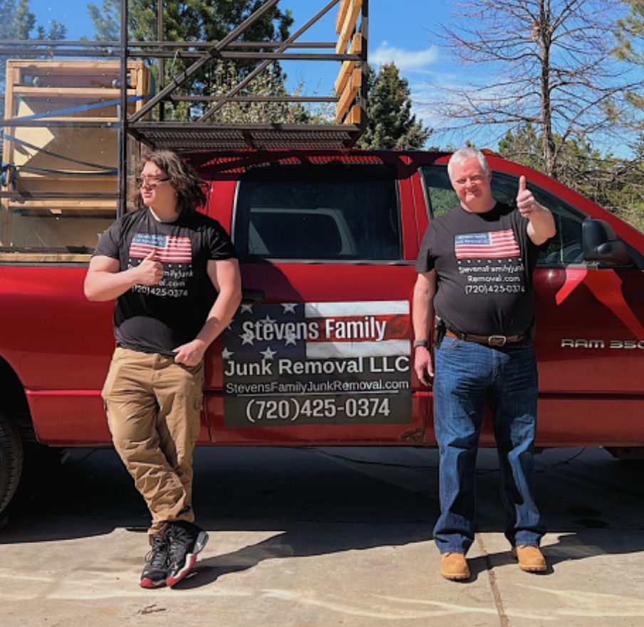 Our Pickup Truck With Siding for Junk Removal Jobs Red pickup truck with wooden frames and mesh structure loaded in the truck bed.